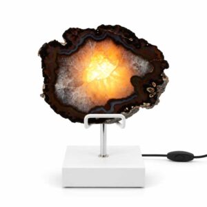 Agaat lamp Nova met witte standaard, donkere agaatrand en warm verlicht kristalcentrum