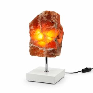 Aragoniet edelsteen lamp Amber Glow met warme oranje gloed op witte standaard